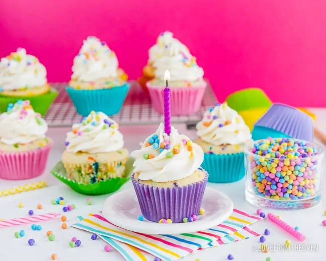 Funfetti cupcakes on a table that is prepared for a party