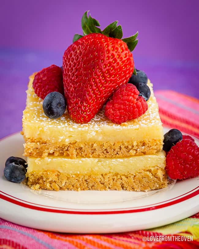 A piece of cake on a plate, with fruit toppings