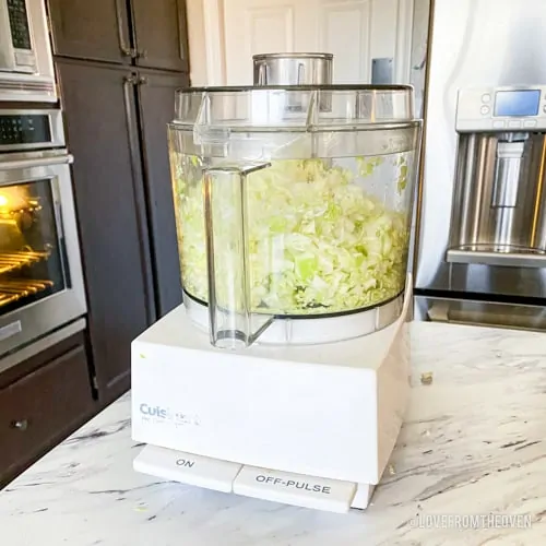 Food processor chopping cabbage for a KFC coleslaw copycat recipe