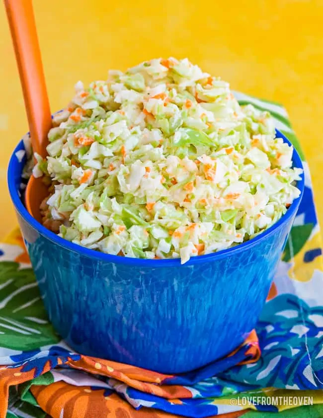 Bowl of KFC Coleslaw Recipe in a blue bowl with a yellow background
