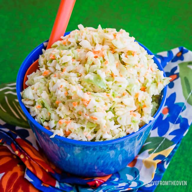 Bowl of KFC Copycat Coleslaw on a green background