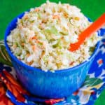 Blue bowl holding KFC Coleslaw Copycat Recipe with a green background