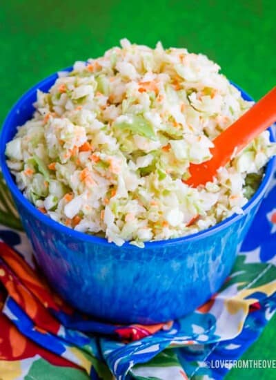 Blue bowl holding KFC Coleslaw Copycat Recipe with a green background