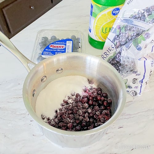 Pan with ingredients to make blueberry compote