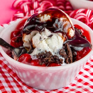 White bowl with chocolate cherry dump cake in it