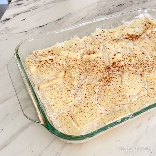 ingredients to make peach dump cake in a glass baking dish