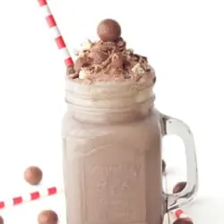 a chocolate malt milkshake with red and white straw
