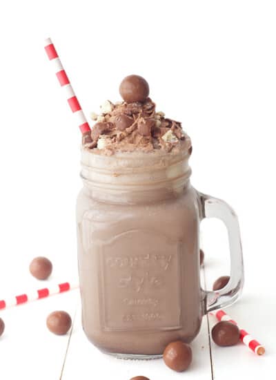 a chocolate malt milkshake with red and white straw