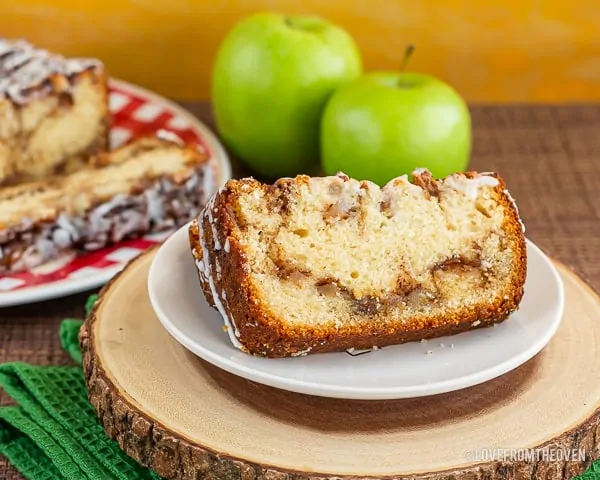 Slices of apple fritter bread in front of apples