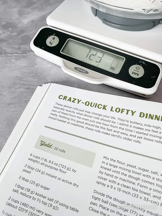 Cookbook and food scale on counter