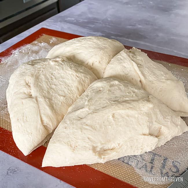 bread dough cut into four pieces