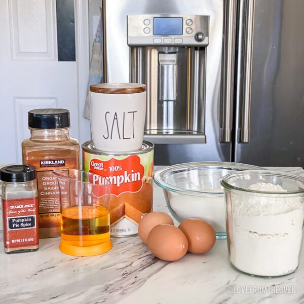 Ingredients to make pumpkin donuts sitting on a counter