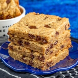 Brown butter blondies stacked on a blue plate