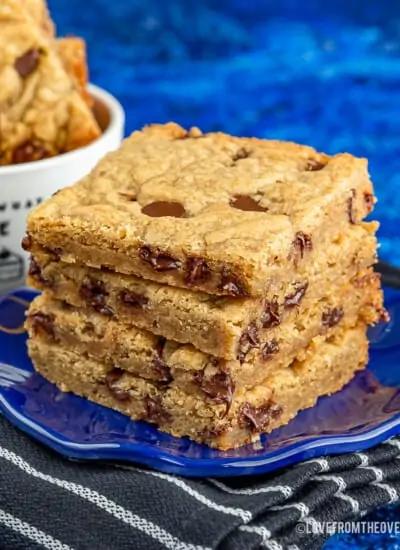 Brown butter blondies stacked on a blue plate