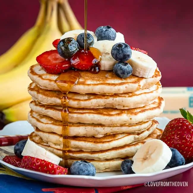 Stack of pancakes topped with fruit