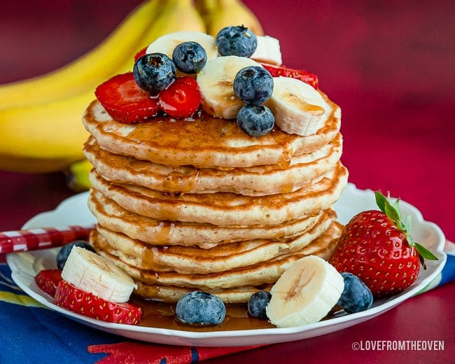 Stack of banana pancakes with fruit