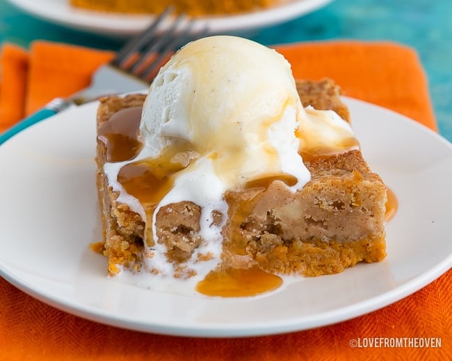 piece of pumpkin dump cake on a white plate with orange napkin