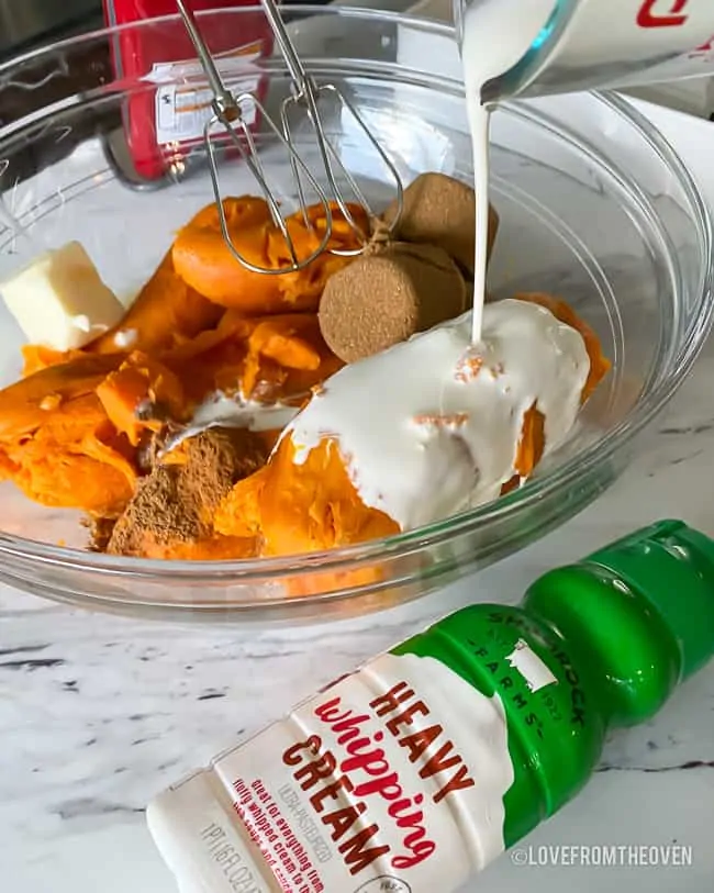 A bowl with ingredients to make sweet potato casserole 