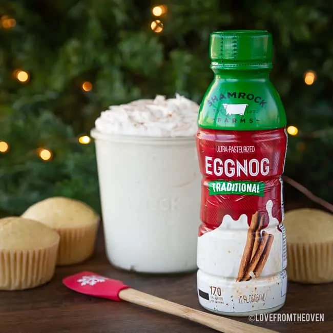 bottle of eggnog with cupcakes and frosting