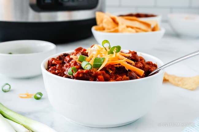 chili in a white bowl on a kitchen counter