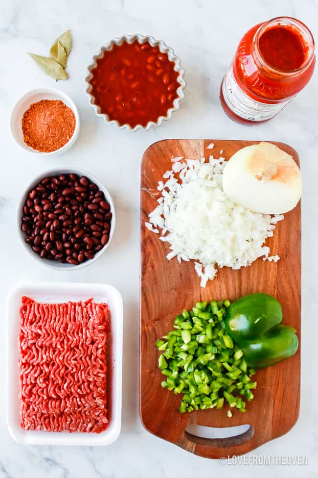 Ingredients for beef chili on a white counter 