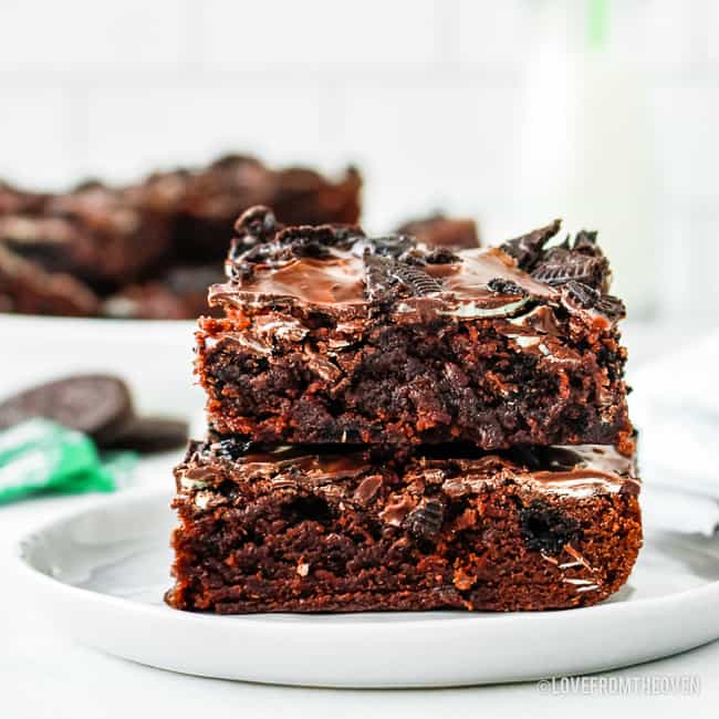 two mint brownies stacked on each other on a white plate