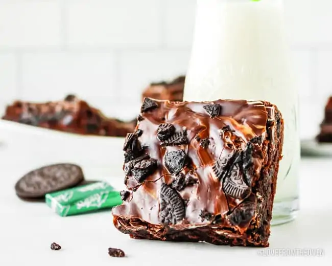 A andes brownie leaning against a glass of milk
