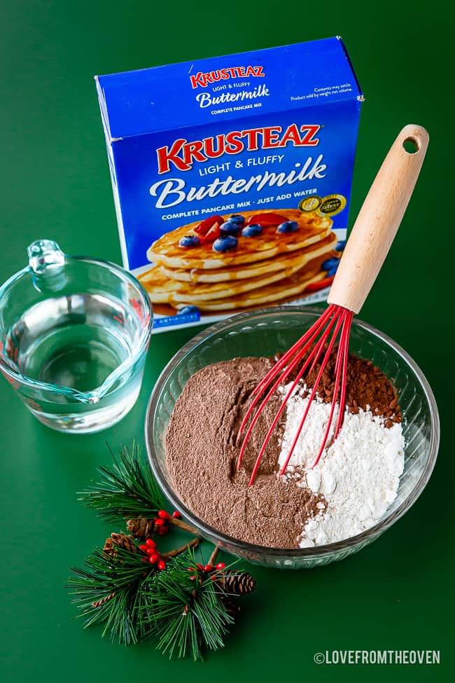 A box of Krusteaz pancake mix with a bowl of pancake ingredients