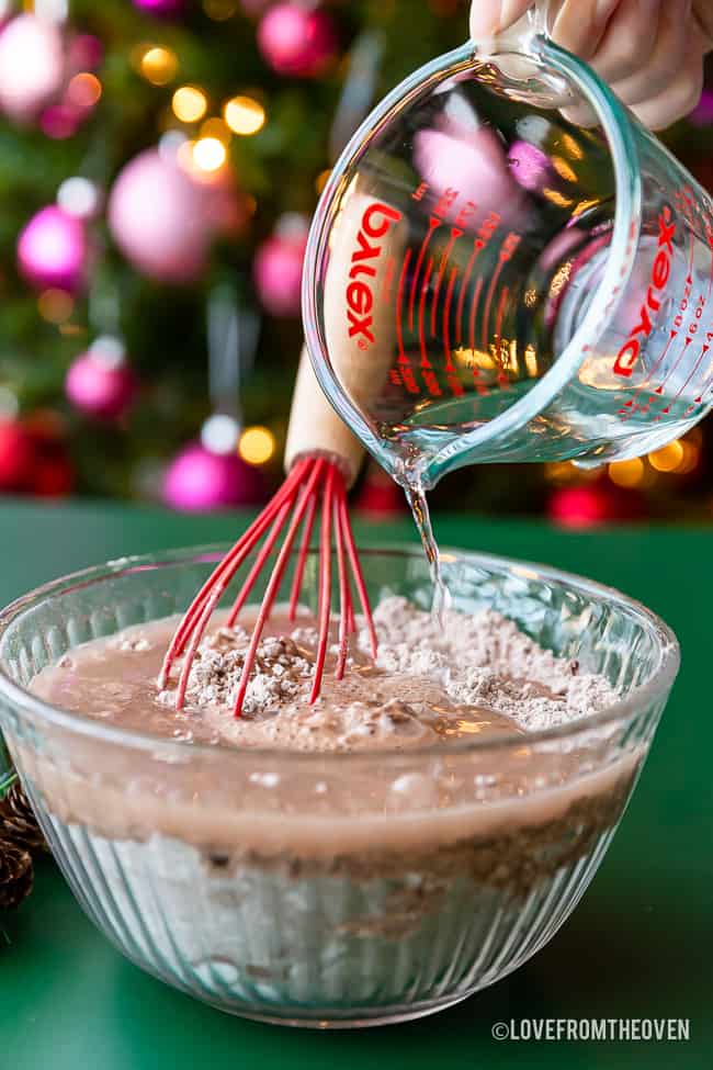 Water being poured into chocolate pancake mix