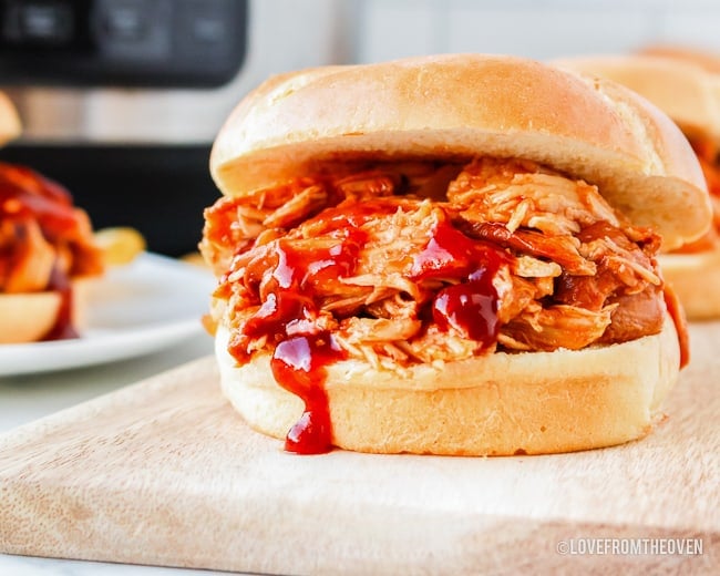 a bbq chicken sandwich on a cutting board