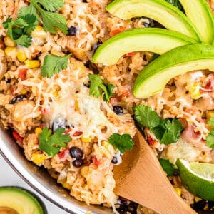 Skillet of chicken and rice topped with avocados