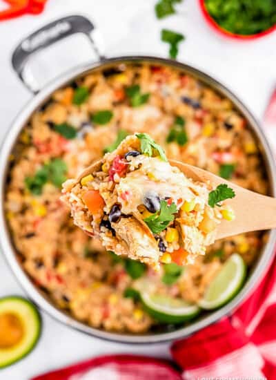 Spoonful of chicken and rice over a skillet