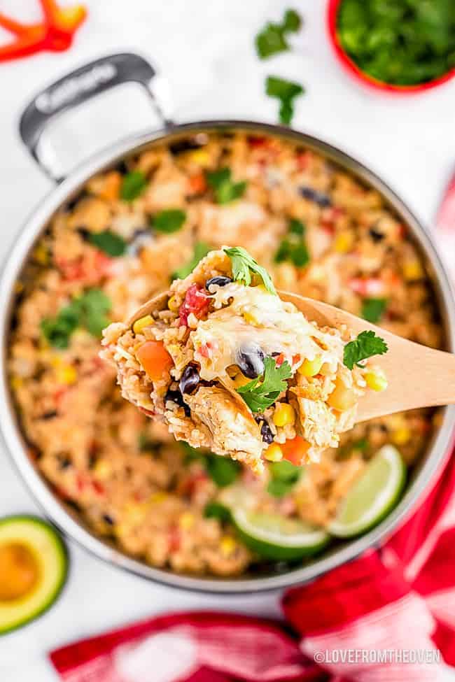 Spoonful of chicken and rice over a skillet