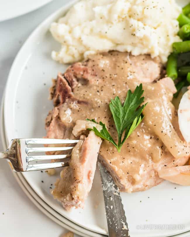 porkchops on a plate being cut