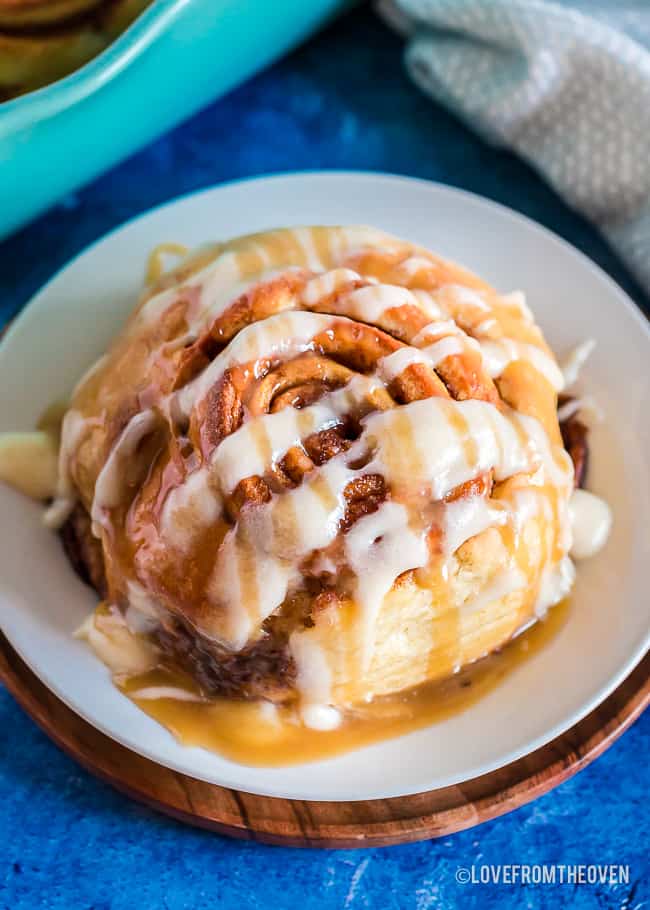 Close up of a homemade cinnamon roll on a white plate