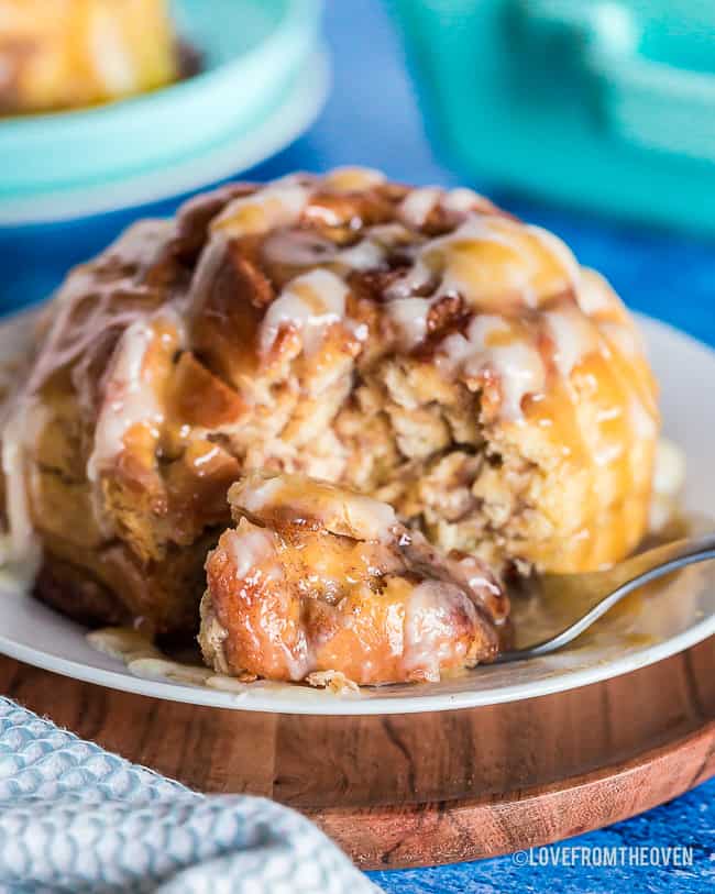 a giant cinnamon roll with one bite on a fork