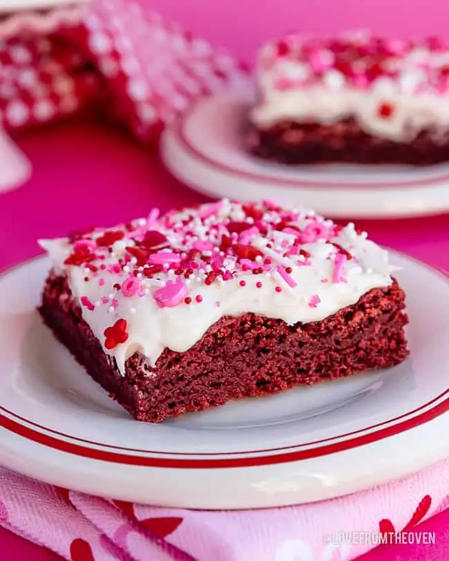 a red velvet brownie with cream cheese frosting and valentine sprinkles