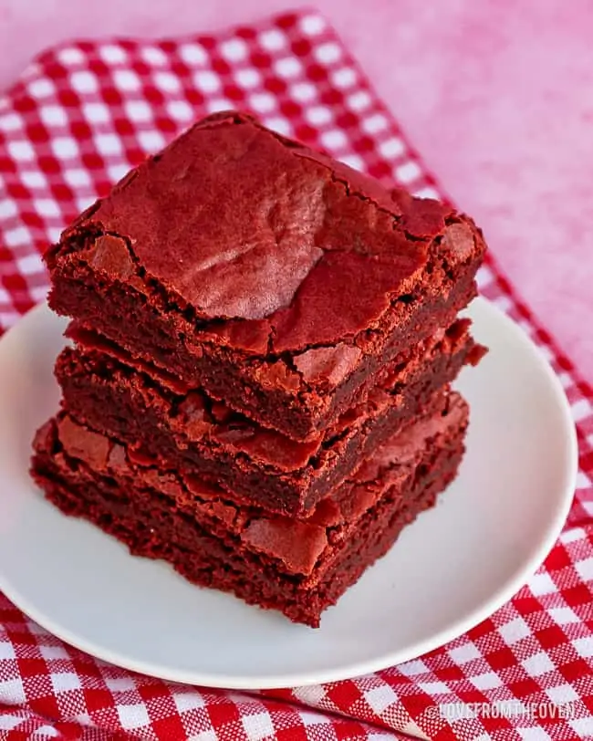 stack of red velvet brownies on a red gingham napkin