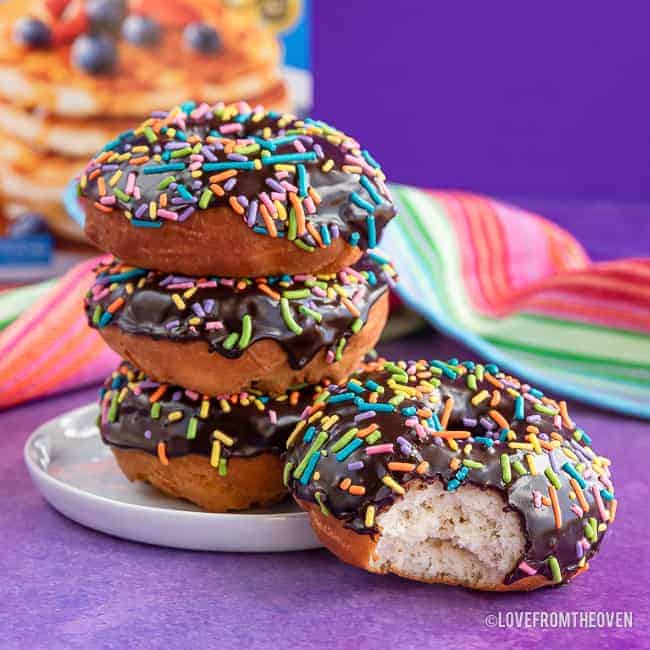 a stack of donuts on a purple background