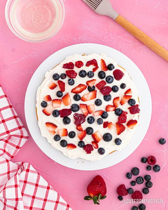 A chantilly cake topped with berries