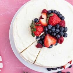 An overhead shot of a chantilly cake with berries on top.