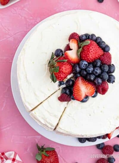 An overhead shot of a chantilly cake with berries on top.