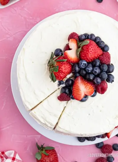 An overhead shot of a chantilly cake with berries on top.