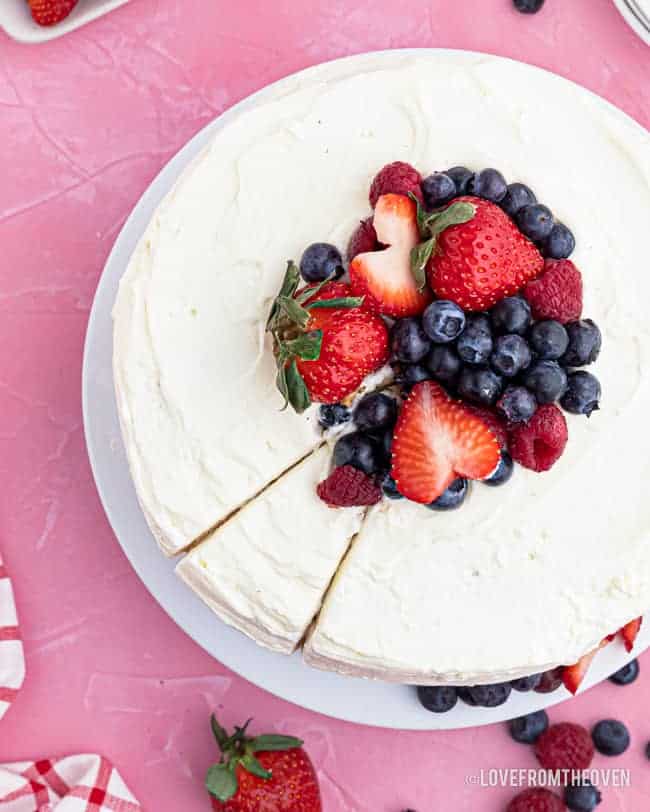 overhead photo of chantilly cake topped with berries