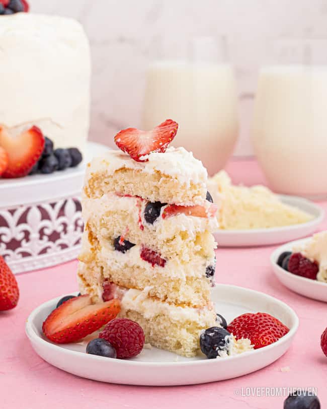 A slice of chantilly cake with berries