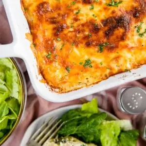 overhead shot of chicken lasagna and a salad