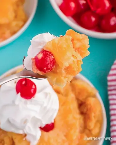 A pineapple upside down cake with a spoonful being held up