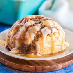 A giant cinnamon roll on a white plate