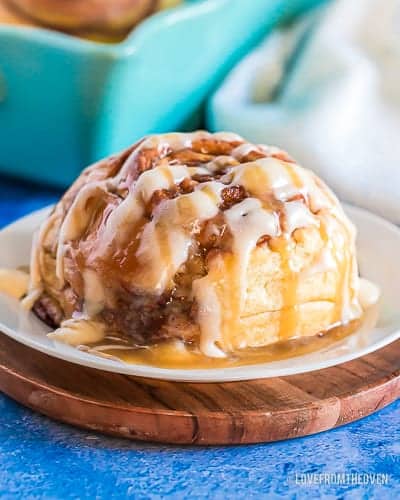 A giant cinnamon roll on a white plate