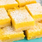 lemon bars on a blue cake plate